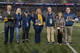 Dr. Gee stands with the recipients of the 'Most Loyals' awards on Mountaineer Field.