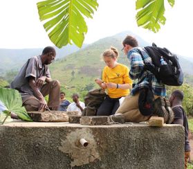 WVUEWB members work with locals to test the water supply in Kabughabugha.