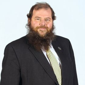 man with long brown beard in suit