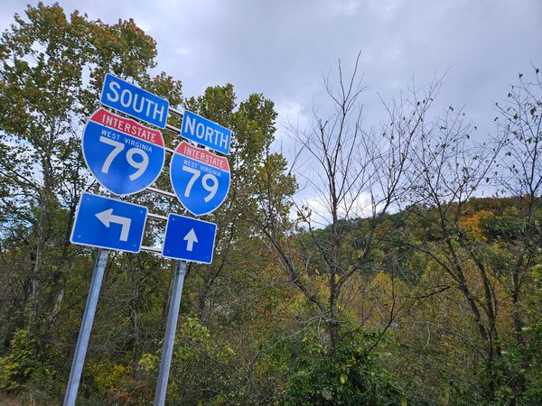 A pair of road signs labeling directions on Interstate 79. 