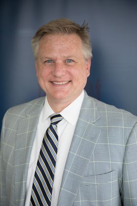 smiling man in plaid suit, striped tie