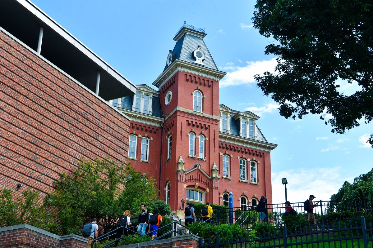 Students walk to class by climbing the steps near Woodburn Hall on the WVU campus in August 2017.