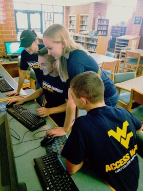 High school students gathered around a computer