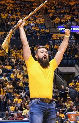 Trevor Kiess celebrates with raised arms Saturday, Feb. 24, as he's named the 2018-19 Mountaineer Mascot