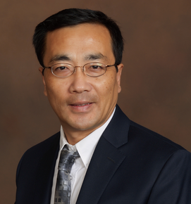 Portrait of John Hu, he is wearing glasses and a suit and tie. He has short black hair and a clean-shaven face. 