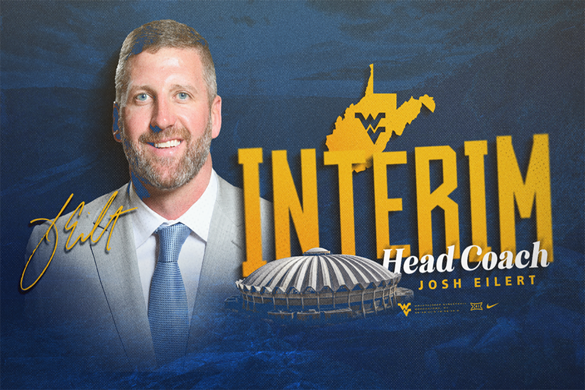 This is gold and blue graphic. On the left is Josh Eilert. On the right, under a gold WV outline with the Flying WV in blue are the words Interim Head Coach and a picture of the top of the Coliseum.