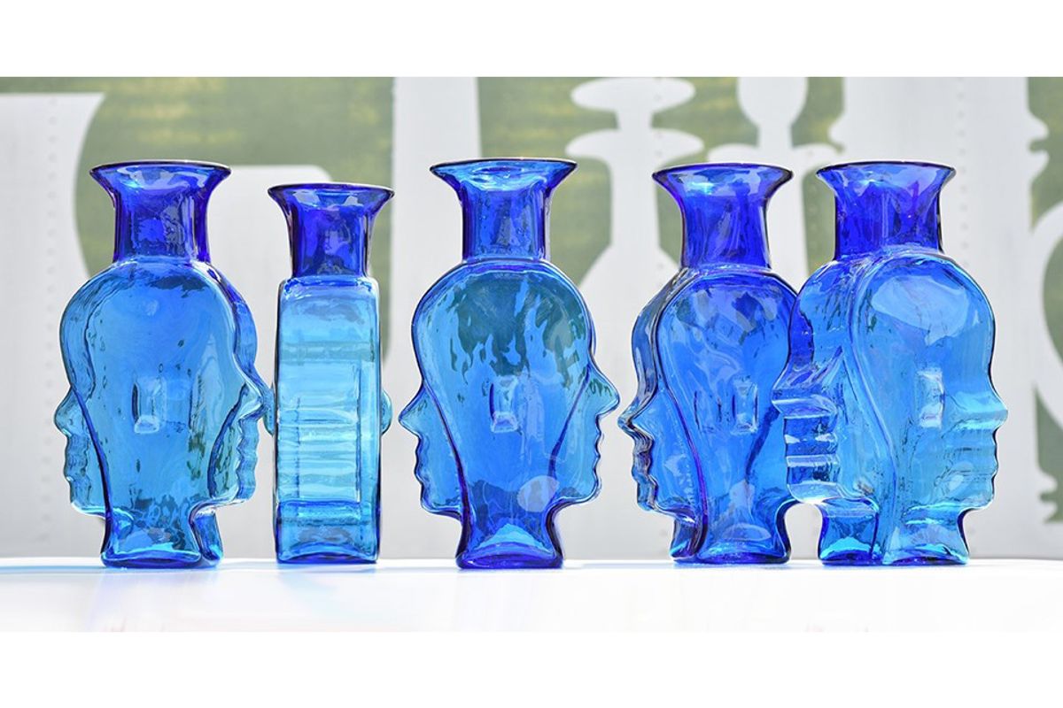 row of blue glass vases with odd shapes, curves