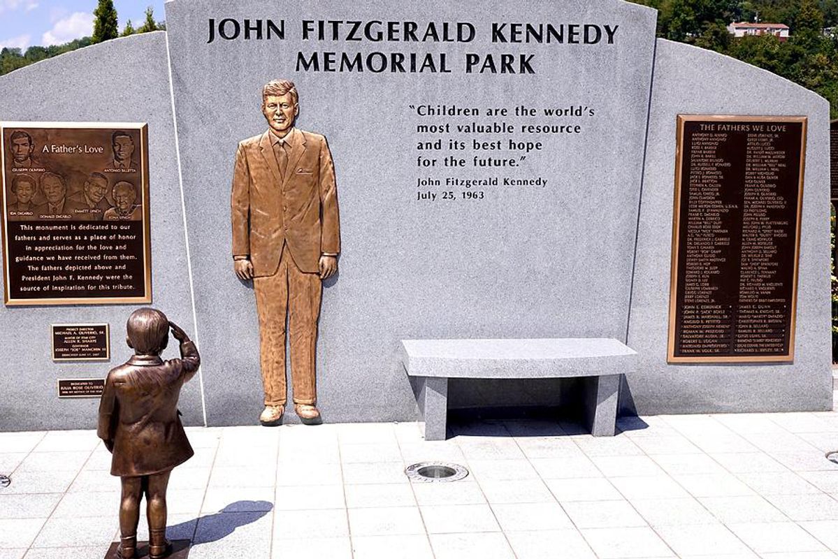 Grey structure with JFK figure in gold and two plaques