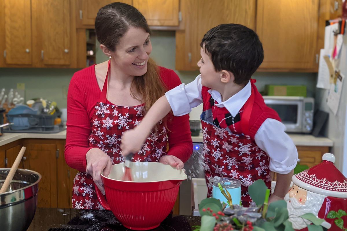 A woman and young boy posed while mixing ingredients into a bowl