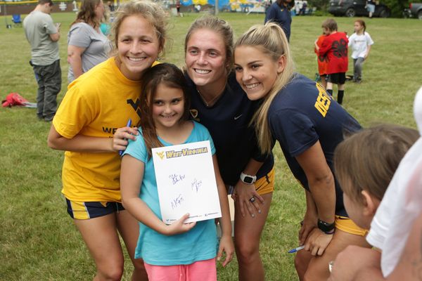 Members of the WVU women's soccer team visit with McDowell County 4-H Soccer League
