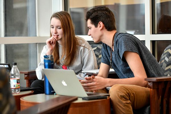 A female college student works beside a male college student within WVU's library