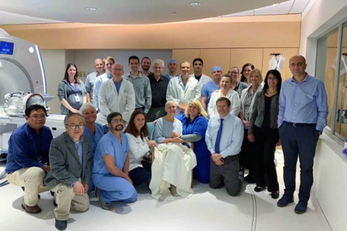 The team from the WVU Rockefeller Neurosciences Institute, led by Ali Rezai, M.D. (standing, ninth from left), poses for a picture with Judi (seated, front row), the first patient to undergo focused ultrasound as part of the phase II clinical trial.