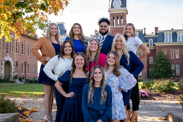 The ten Homecoming candidates stand in front of Woodburn Hall on the WVU Downtown Campus. Part of Martin Hall is shown in the background.