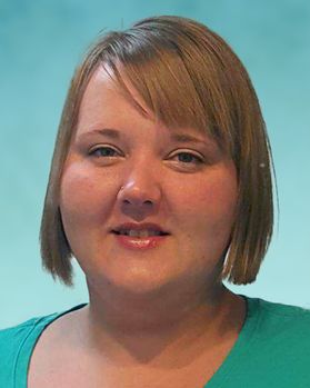 Headshot of WVU program manager Michelle Fleece. She is pictured in front of a light blue wall and is wearing a kelly green shirt. She has blond hair cut in a short bob. 