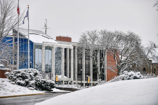 snowy scene on college campus with road