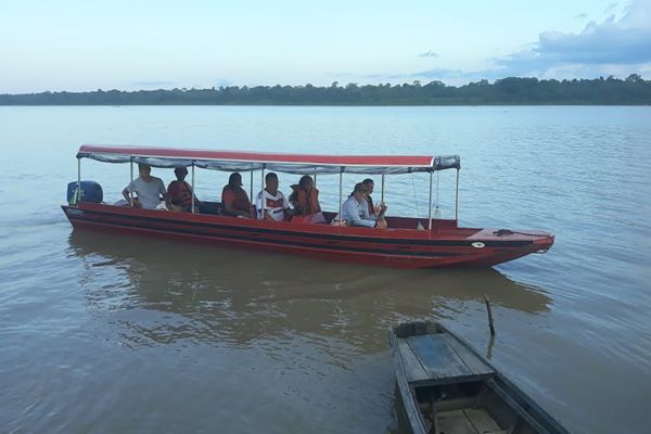 An image showing a local boat with passengers on the Amazon River.