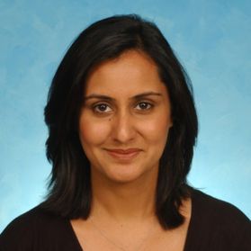 Headshot of WVU professor Amna Umer. She is pictured against a light blue background and is wearing a black top. She has shoulder length dark hair. 