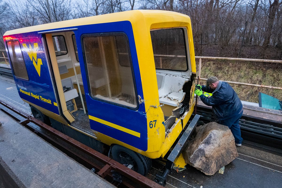 WVU personnel work on the PRT tracks after a rock slide Monday, Feb. 10, 2020. To safely remove people from the PRT vehicle, emergency officials needed to remove a large portion of the vehicle.