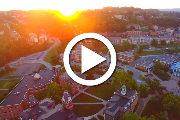 The WVU Campus with a video play button over it.