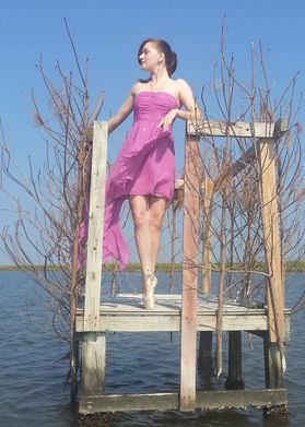 A ballerina on pointe stands in a duck blind