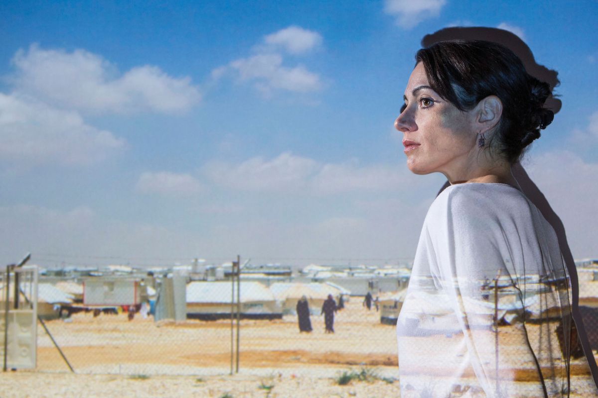 photo illustration of woman superimposed over photo of refugee camp