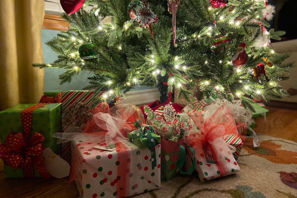 Image of a Christmas tree with wrapped gifts underneath.