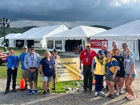 A group of 13 volunteers from WVU post near health care tents at the Boy Scouts National Jamboree. 