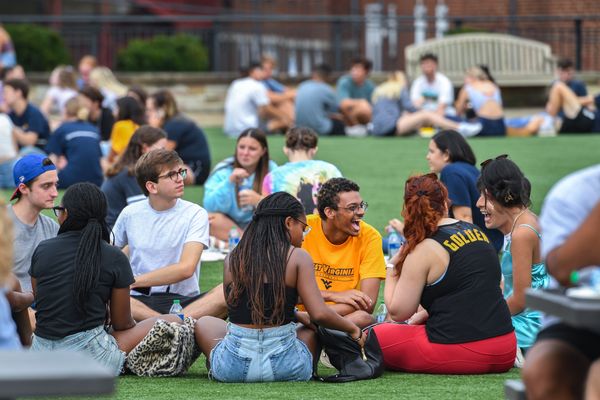 Students sit and talk on the Mountainlair Green