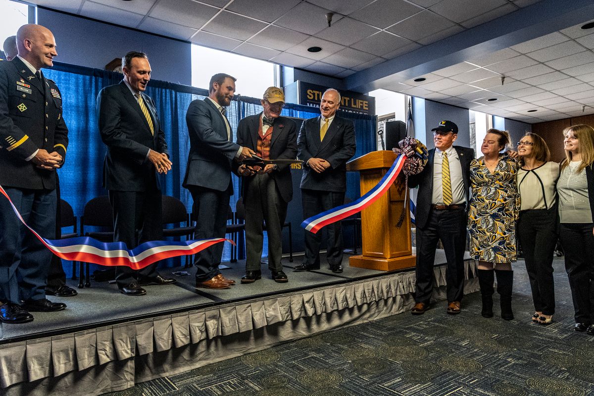 Platform party members watch as L to R, Ed E. Olesh, president, Veterans of WVU, and WVU President E. Gordon Gee cut the ribbon opening the new WVU Veteran and Military Family Support Headquarters December 7, 2018. Photo Greg Ellis