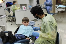 Dentist works on child.