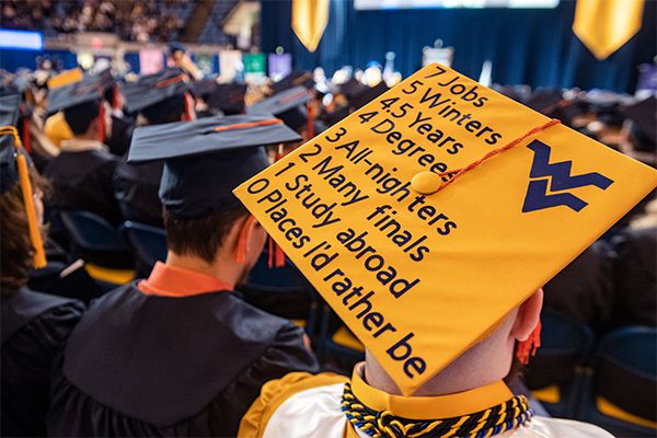 gold mortarboard with blue text