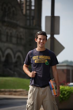 Smiling boy in WVU shirt.
