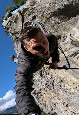 Photograph of Rick Loughery climbing a huge rock face.