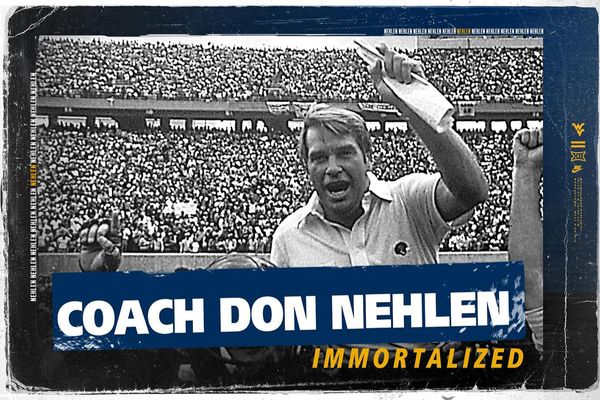 Don Nehlen is shown in a black and white photo at Mountaineer Field. Included are the words Coach Don Nehlen in white and 'immortalized' in gold.