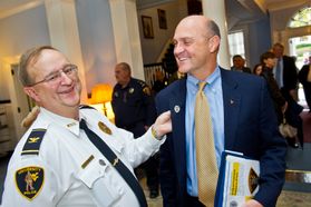 WVU Police Chief Bob Roberts, left, laughs as he and President James P. Clements talks at the conclusion of the UPD 50th anniversary celebration in October 2011.