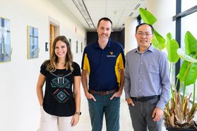 Three WVU researches are pictured here. Carley Singleton has shoulder-length hair and is wearing a black shirt and tan pants. Kevin Orner is standing in the middle wearing a blue and gold polo shirt with jeans. And Lian-Shin Lin is on the right  in blue. 