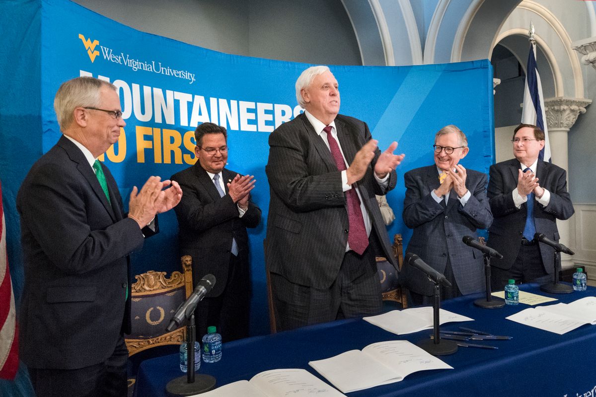 Marshall University President Jerome Gilbert (far left), West Virginia University President Gordon Gee (right), West Virginia School of Osteopathic Medicine President Dr. Michael Adelman (far right) join Governor Jim Justice (center) for signing of HB 2815 (Relating to High Education Governance) at Stewart Hall on the WVU Morgantown Campus April 25, 2017.