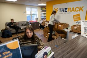 Students work unpacking boxes and on a computer at The Rack, the food pantry on the WVU Campus. 