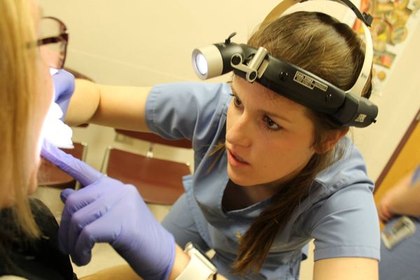 WVU School of Dentistry student examines a patient