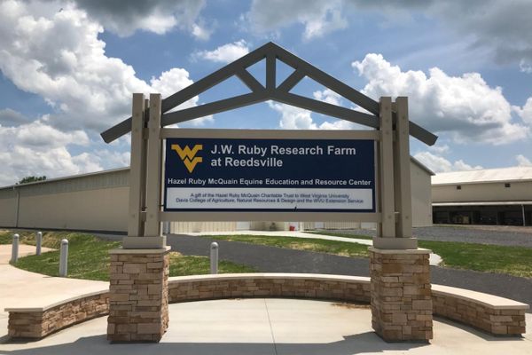 Sign that says J.W. Ruby Research Farm at Reedsville, Hazel Ruby McQuain Equine Education and Resource Center. A gift of the Hazel Ruby McQuain Charitable Trust to West Virginia University Davis College of Agriculture, Natural Resources & Design and the  