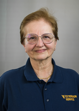 Woman posed smiling with glasses on