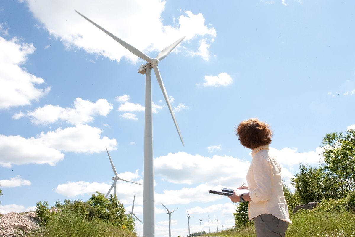 Woman taking notes on wind turbines
