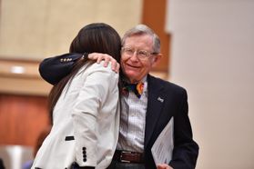 Dr. Gee hugs a student at WVU's Lavender graduation.