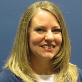 Headshot of WVU conservation specialist Stephanie Toothman. She is pictured in front of a blue background and she has long blonde hair. 