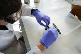 A forensic researcher works with test tubes