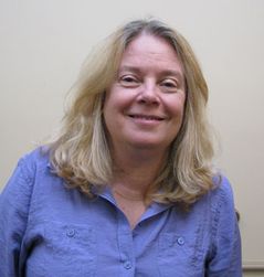 Photo of smiling white woman in blue shirt