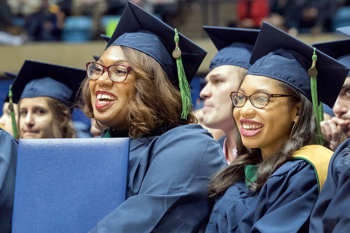 WVU Pathologists assistants Dominique Johnson and Chestia Long listen to speakers at the WVU commencement December 15, 2017.