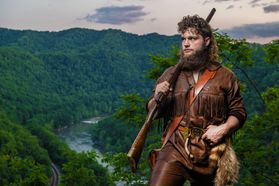 Mikel Hager poses in the buckskins with the rifle along the ridge of the New River. 