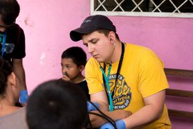 A WVU student provides care to people in Nicaragua as part of the Global Brigade.