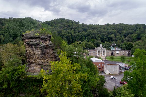 a large rock formation outside a town, focusing on a courthouse